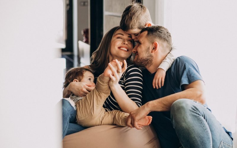 Young family with their sons at home having fun