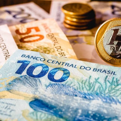 In this photo illustration being displayed one hundred and two hundred reais bills and a one reais coin highlighted. The Real is the current money in Brazil.